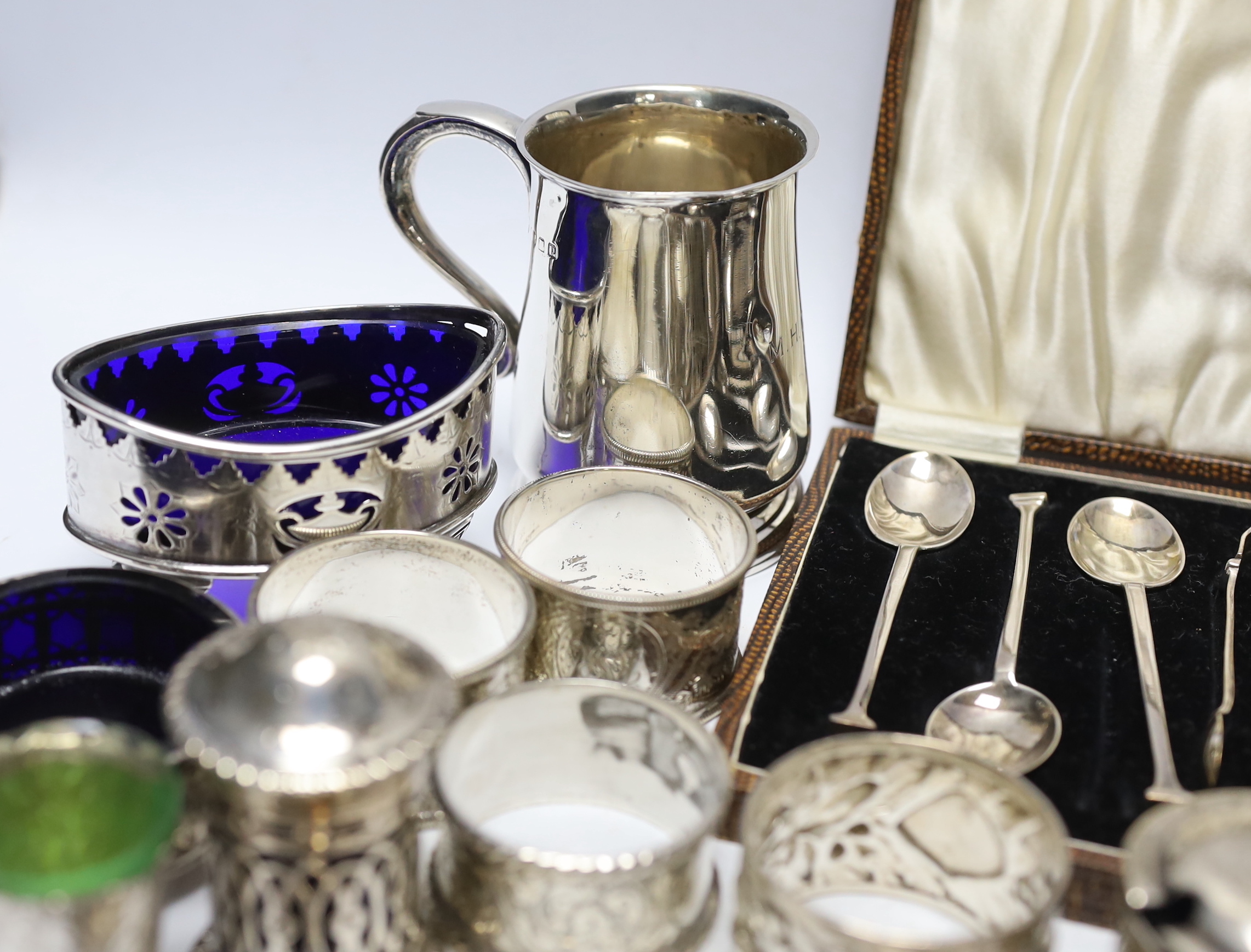 A collection of small silver to include a christening cup, a pair of late Victorian navette shaped salts, a Chinese white metal cruet (incomplete), flatware including cased teaspoons, vest case, napkin rings, etc.